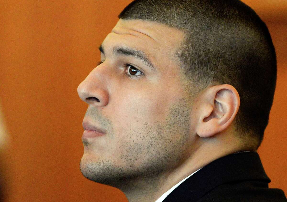 FILE - In this Tuesday, July 22, 2014, file photo, former NFL football player Aaron Hernandez watches during a hearing in Bristol County Superior Court, in Fall River, Mass. A judge is hearing arguments, Tuesday, Sept. 30, 2014, on a bid by Hernandez's lawyers to have additional evidence in a murder case against him thrown out. (AP Photo/CJ Gunther, Pool, File)