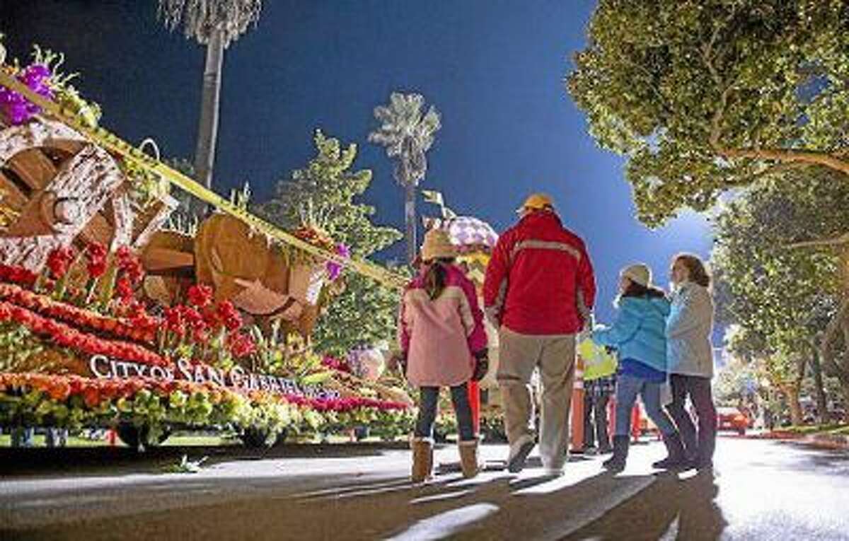 The Placido family of Alhambra enjoys an early morning stroll along Orange Grove Boulevard to view the Rose Parade floats before they embark on the annual 5.5 mile route through Pasadena Jan. 1, 2013.