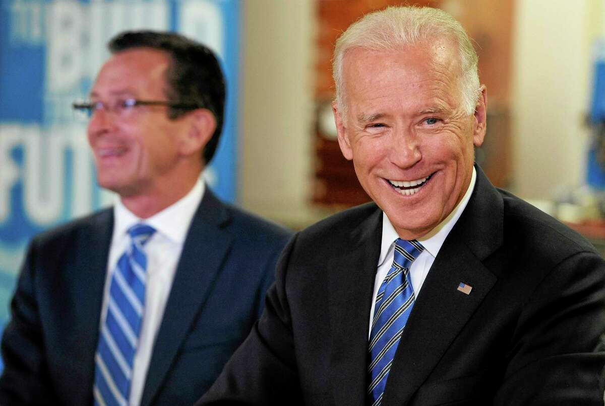 Vice President Joe Biden, right, smiles as he attends a roundtable on workforce development with Connecticut Gov. Dannel P. Malloy, left, at Goodwin College, Wednesday, Aug. 20, 2014, in East Hartford, Conn. (AP Photo/Jessica Hill)
