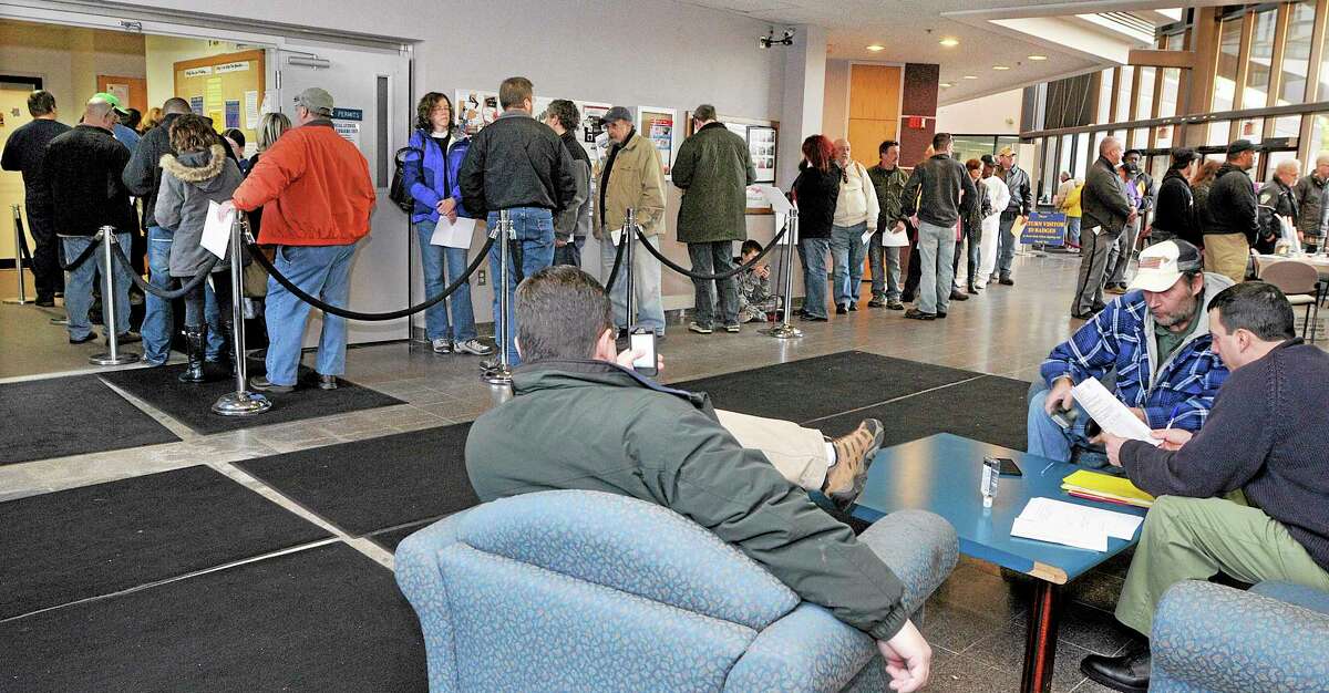 In this Dec. 27, 2013 photo, gun owners wait in line at the State of Connecticut Department of Public Safety office in Middletown, Conn., to renew hand gun permits, and register firearms classified as assault weapons prior to the Jan. 1 deadline. The new regulations were enacted in April in response to the Sandy Hook Elementary School shooting. (AP Photo/The Middletown Press, Catherine Avalone)