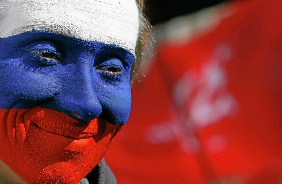 A pro Russian activist with his face painted in the colors of the Russian flag attends rally at a central square in Donetsk, eastern Ukraine, Saturday, March 22, 2014. More than 5,000 pro-Russia residents of this major city in Ukraine's east have been demonstrating in favor of holding a referendum on secession. The rally in Donetsk comes less than a week after voters in Crimea approved a similar referendum and Russia formally annexed the territory. (AP Photo/Sergei Grits)