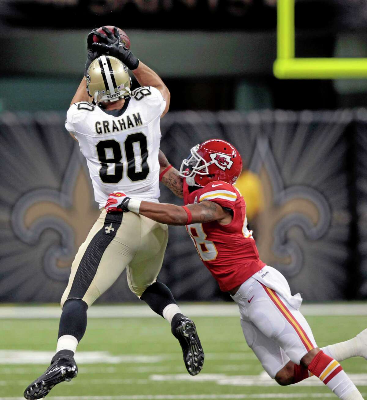 New Orleans Saints tight end Jimmy Graham (80) pulls in a pass over Kansas City Chiefs safety Bradley McDougald during the first half of an NFL preseason football game at the Mercedes-Benz Superdome in New Orleans, Friday, Aug. 9, 2013. (AP Photo/Matthew Hinton)