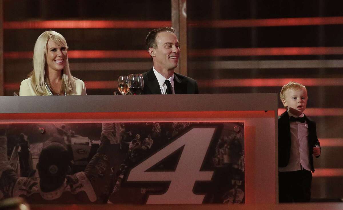 Kevin Harvick, center, and his wife DeLana Harvick, left, watch as their son Keelan reacts to seeing his image on the screen during the NASCAR Sprint Cup Series awards at Wynn Las Vegas last Friday.