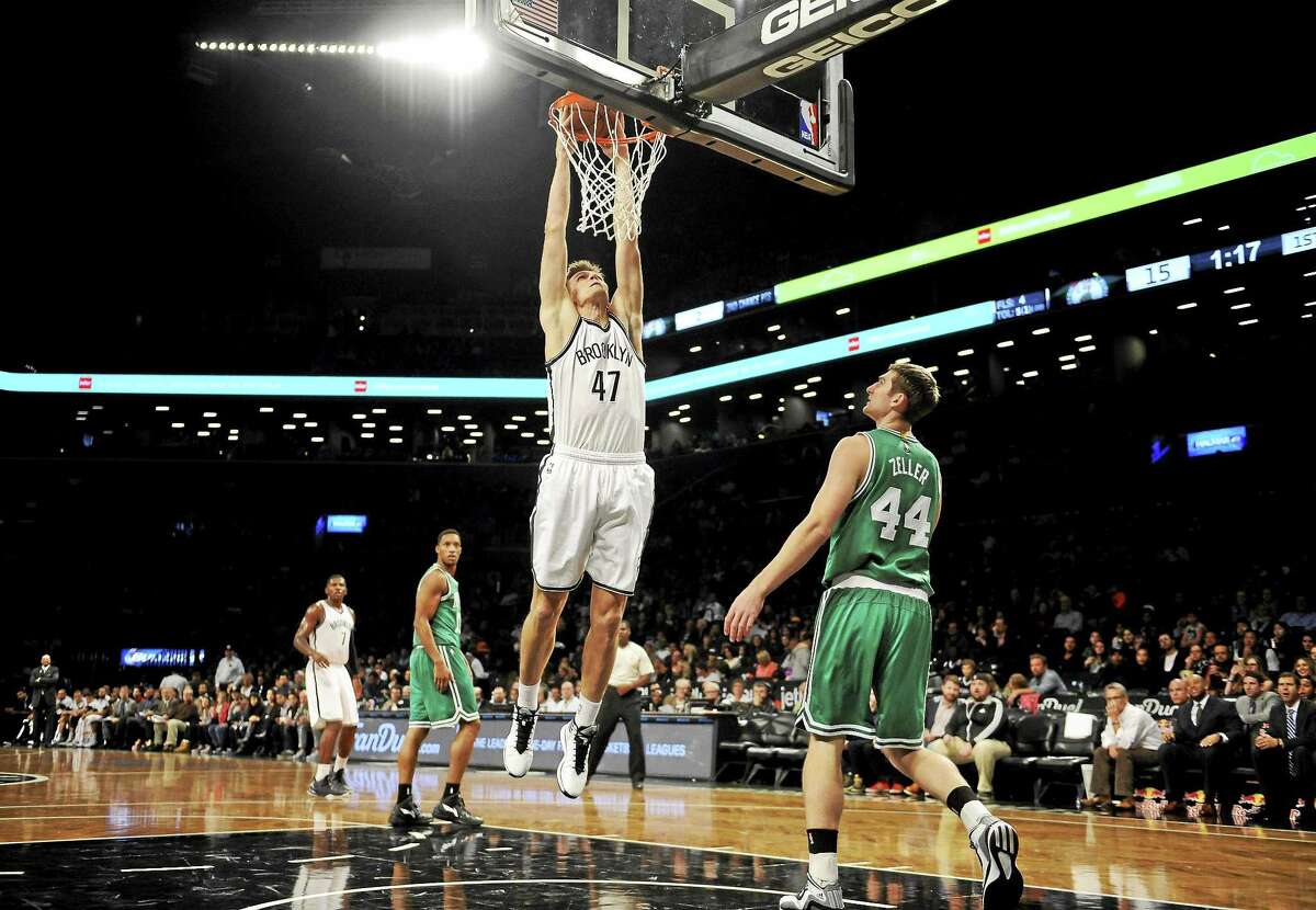 Boston Celtics center Tyler Zeller watches Brooklyn Nets forward Andrei Kirilenko dunk during an Oct. 19 preseason game in New York.