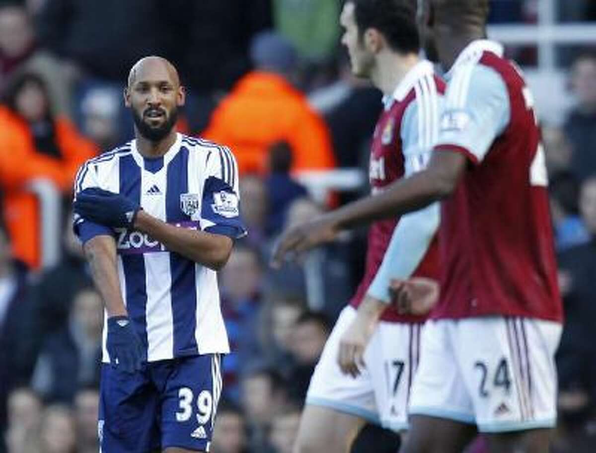 West Bromwich Albion's French striker Nicolas Anelka gestures as he celebrates scoring their second goal during the English Premier League football match between West Ham United and West Bromwich Albion.
