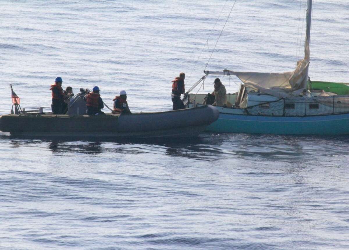 This photo provided by the U.S. Navy, sailors assigned to the Arleigh Burke-class guided-missile destroyer USS Paul Hamilton (DDG 60) rescue Ron Ingraham on Tuesday, Dec. 9, 2014 near Hawaii. Ingraham, 67, was found dehydrated and hungry after going missing on Thanksgiving, when the Coast Guard picked up his mayday call saying his boat was in danger of sinking. (AP Photo/U.S. Navy)