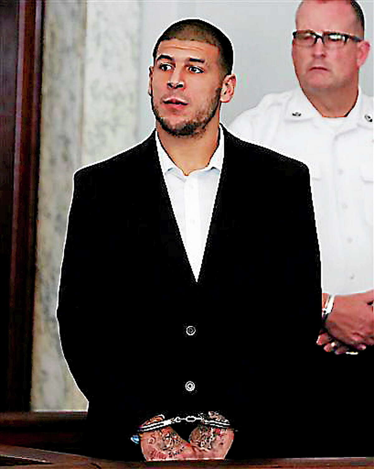 Former New England Patriots NFL football tight end Aaron Hernandez appears at Attleboro District Court on Wednesday, July 24, 2013, in Attleboro, Mass. Hernandez has pleaded not guilty to murder in the death of Odin Lloyd. Hernandez was in court for what was supposed to be a probable cause hearing, but prosecutors said the grand jury is still considering the evidence against him. A judge rescheduled the probable cause hearing for Aug. 22, after considering defense objections to a delay. (AP Photo/Bizuayehu Tesfaye)