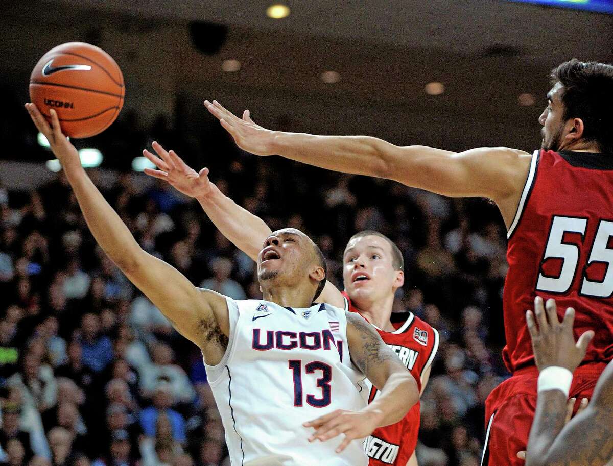 UConn’s Shabazz Napier (13) drives past Eastern Washington’s Parker Kelly (10) and Venky Jois (55) during the second half of Saturday’s game in Bridgeport.