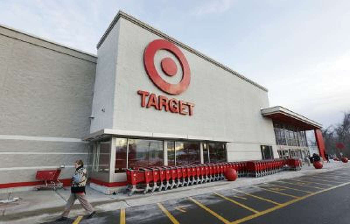 In this Dec. 19, 2013 file photo, a passer-by walks near an entrance to a Target retail store in Watertown, Mass. Target on Friday, Dec. 27, 2013 said that customers' encrypted PIN data was removed during the data breach that occurred earlier this month.