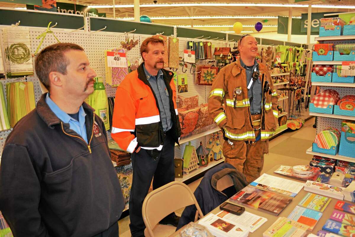 Deputy Fire Marshal Jarred Howe (left) and other fire personnel greeting customers inside JoAnn Fabrics.