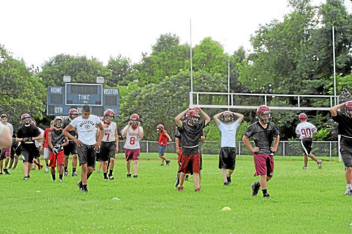 Torrington Red Raider football team members practice on the high school's football field, a $2.7 million renovation of which has become controversial.