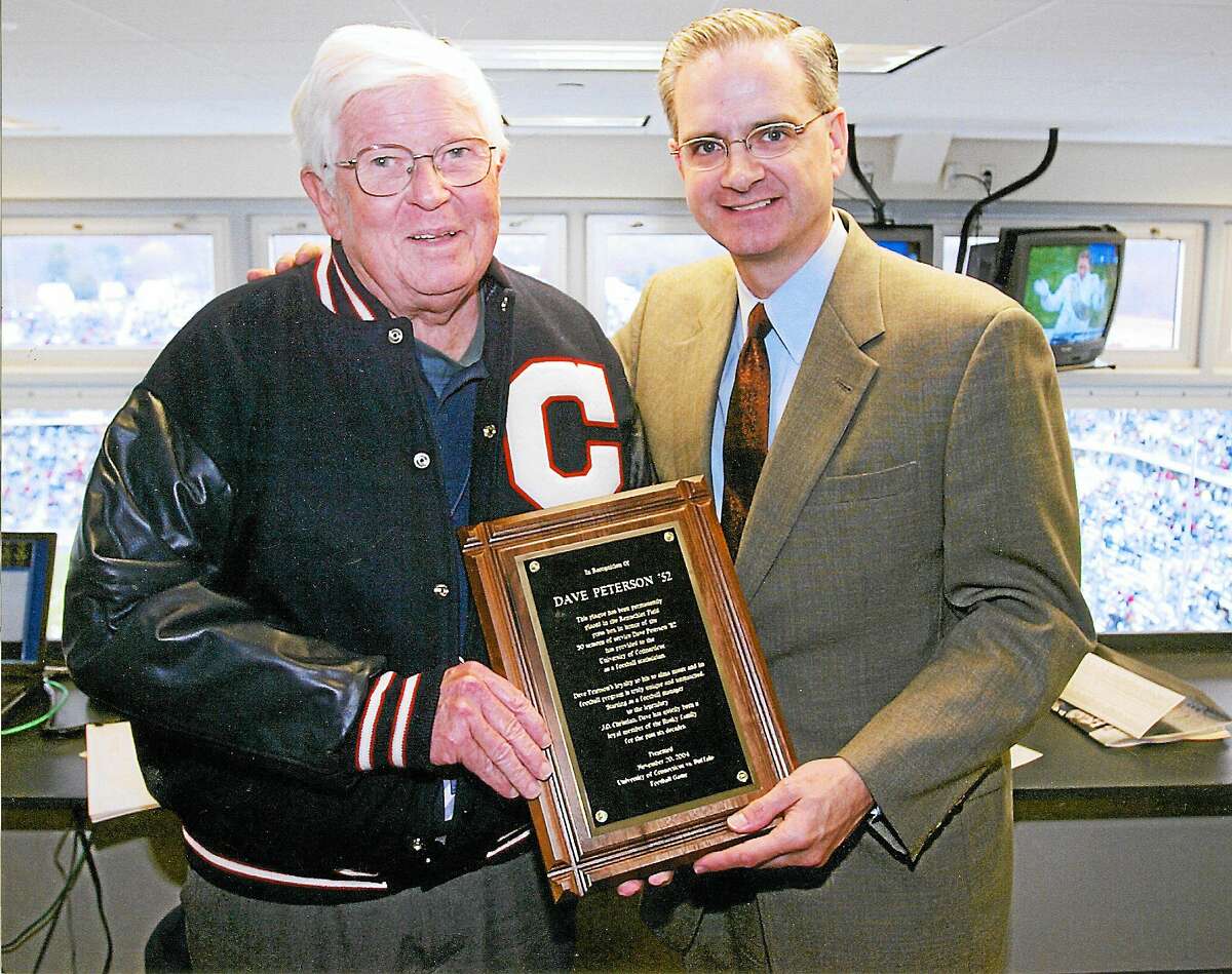 Wallingford’s Dave Peterson, left, poses with former UConn athletic director Jeff Hathaway. Peterson has been statistician for the Huskies’ football team for 60 seasons.