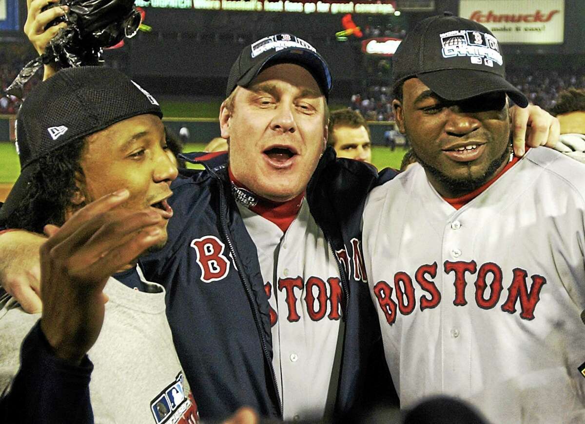 Boston Red Sox players, from left, Pedro Martinez, Curt Schilling and David Ortiz celebrate after defeating the St. Louis Cardinals 3-0 in Game 4 to win the World Series at Busch Stadium in St. Louis on Oct. 27, 2004.