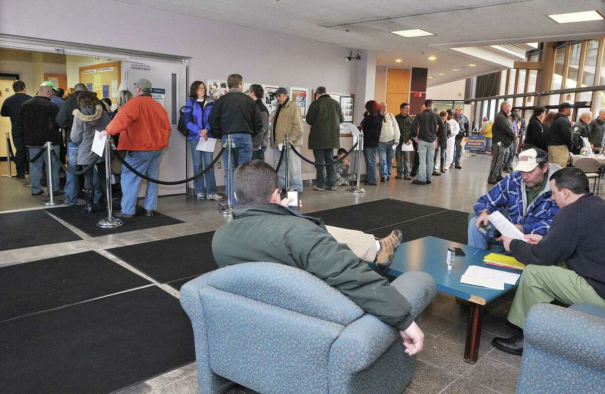 Connecticut gun owners wait in line at the State of Connecticut Department of Public Safety office on Country Club Road in Middletown to register firearms classified as assault weapons under the new regulations established in April in response to the Sandy Hook shooting. The deadline is January 1, 2014. Catherine Avalone - The Middletown Press