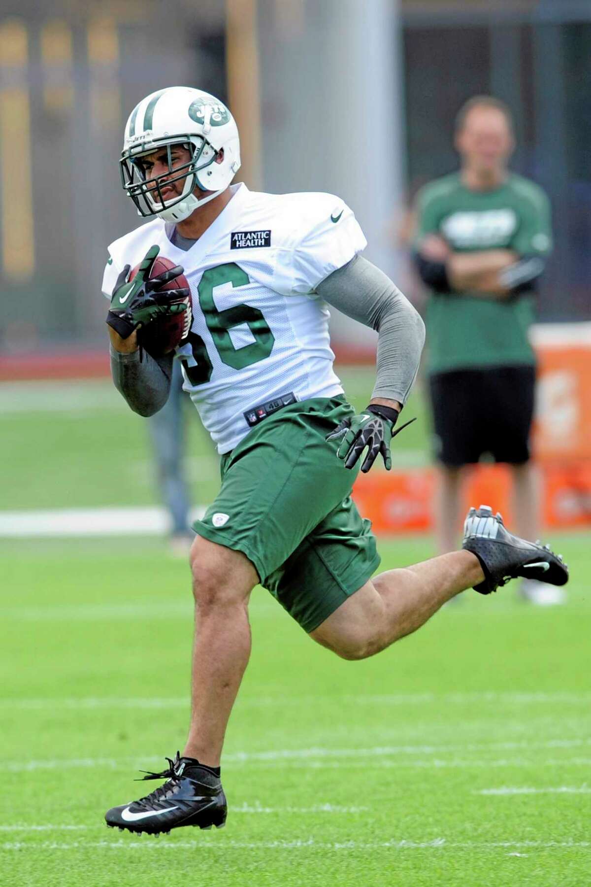 FILE - In this June 11, 2013, file photo, New York Jets fullback Lex Hilliard runs with the ball during NFL football minicamp in Florham Park, N.J. A person familiar with the injury says Hilliard will miss the entire season with a broken shoulder blade that requires surgery. He was injured during practice on Tuesday, Aug. 20, 2013, when he went down after a running play. The person spoke to The Associated Press on condition of anonymity because the team had not announced the severity of Hilliard's injury. (AP Photo/Bill Kostroun, File)