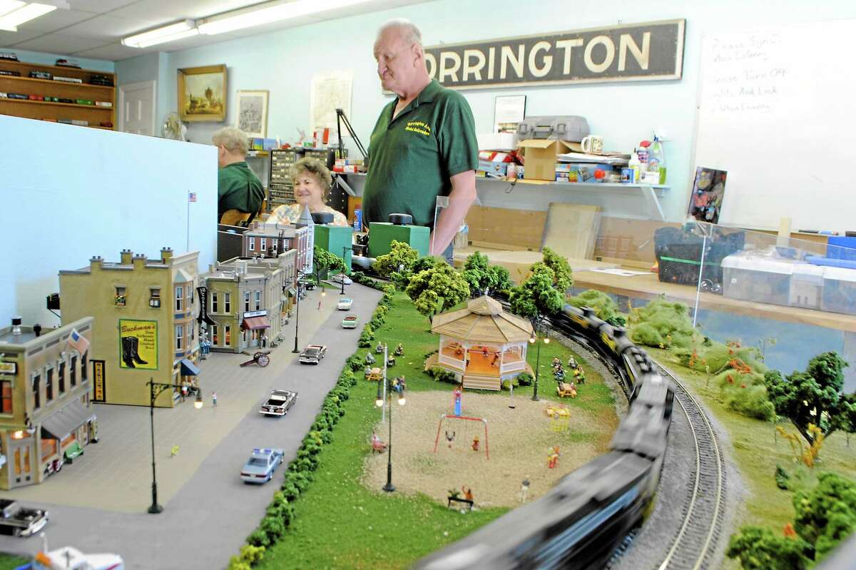 A Torrington Area Model Railroader stands near one of his modular “HO scale” trains.
