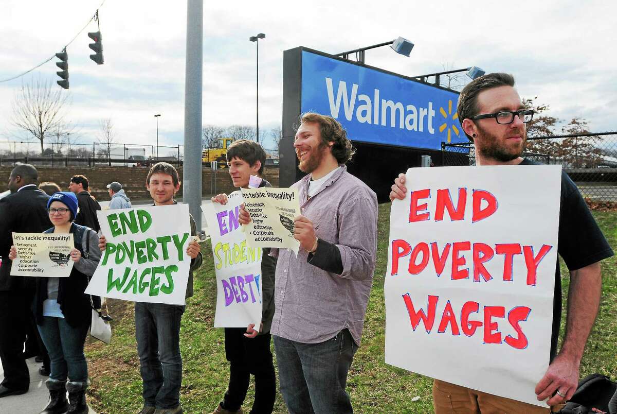 Supporters and members of the Working Families Party, Fast Forward and other progressive groups and individuals demonstrate in front of Walmart in West Haven in this file photo to bring attention to their belief that there is a growing divide between rich and poor in Connecticut.