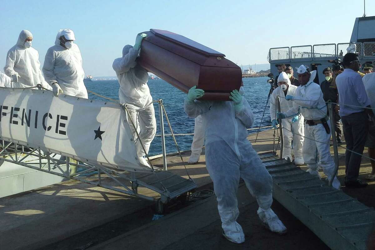 The coffins with bodies of would-be refugees are disembarked in Augusta, Sicily, Tuesday, Aug. 26, 2014. Another 24 bodies were recovered Tuesday from an overturned fishing boat off Italy's southern coast as would-be refugees fleeing increasing instability in Libya saw their deadliest few days this year with more than 300 drowned. The U.N. refugee agency said the worst incident occurred Friday near Garibouli, east of Tripoli. That boat was reportedly carrying at least 270 people when it overturned and sank. Only 19 people survived, according to Melissa Fleming, spokeswoman for the U.N. High Commissioner for Refugees in Geneva. On Tuesday, the Italian navy said two of its patrol boats recovered 24 corpses from a capsized smuggler's boat Sunday night. Their remains, as well as 364 survivors, were headed toward Augusta. (AP Photo/str)