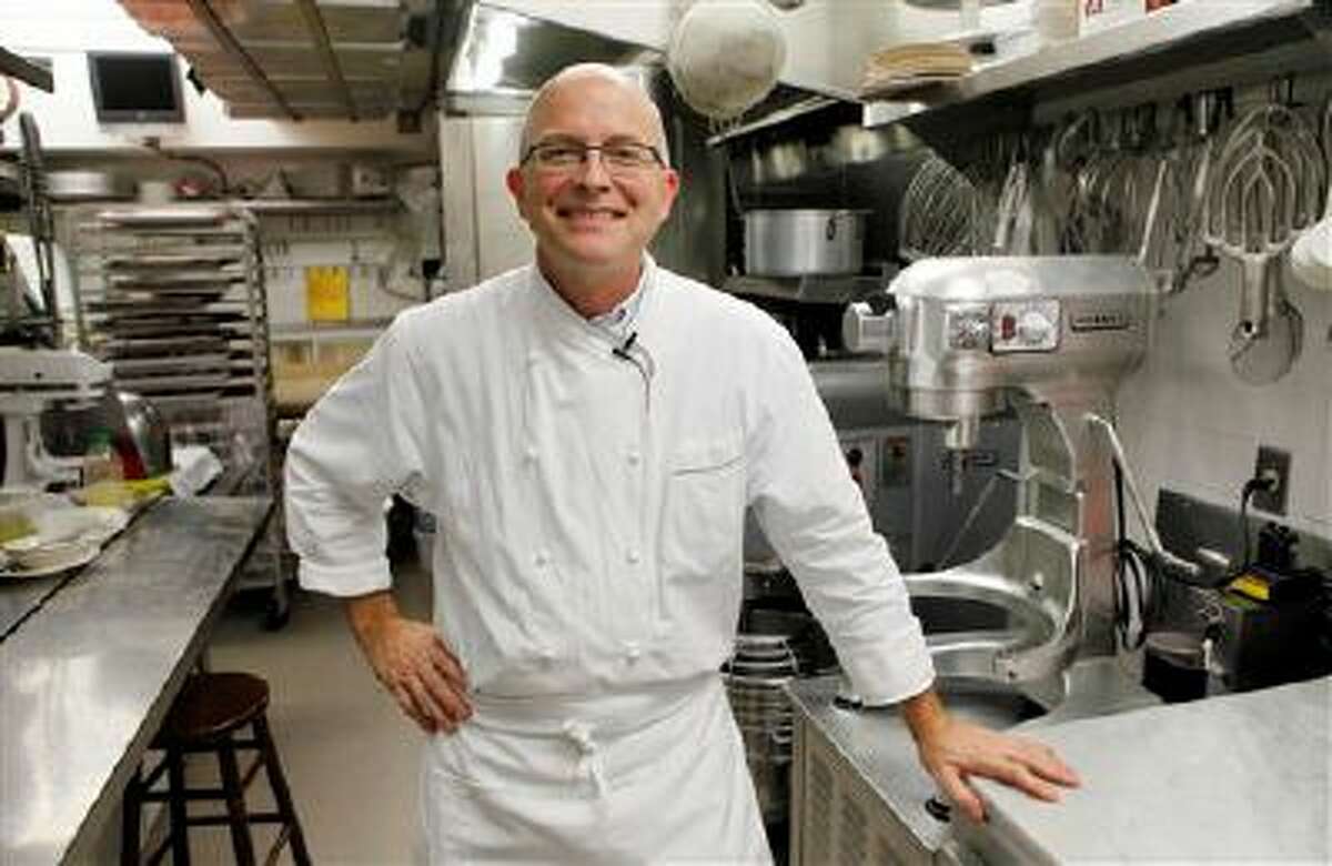 FILE- This Oct. 29, 2009 file photo shows White House pastry chef Bill Yosses as he poses in his kitchen during an interview with the Associated Press at the White House in Washington. Democrats and Republicans may follow their leaders in lockstep on the issues of the day, but when it comes to nuts _ specifically whether or not they belong in chocolate chip cookies _ it seems every politician is an island, says Yosses. (AP Photo/Charles Dharapak, FILE)
