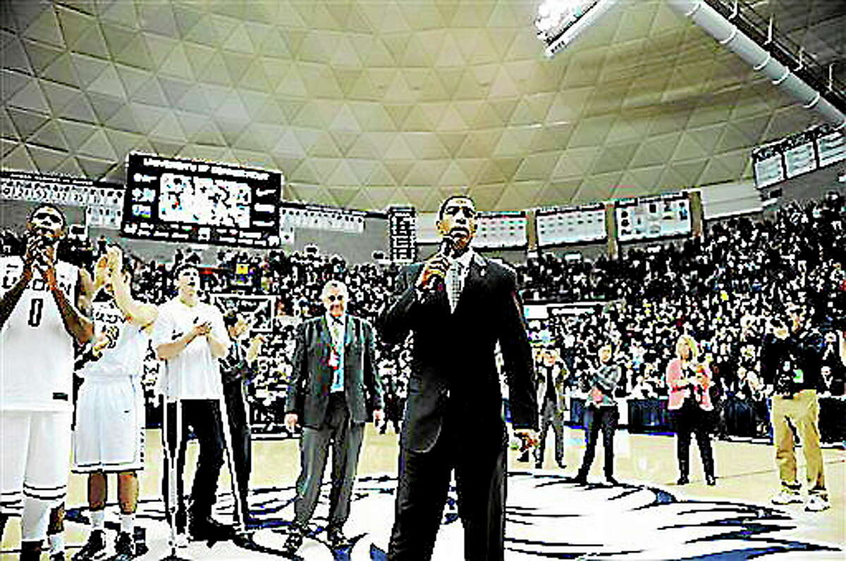 Connecticut coach Kevin Ollie speaks with fans after his team's 63-59 overtime win against Providence in an NCAA college basketball game in Storrs, Conn., Saturday, March 9, 2013. (AP Photo/Fred Beckham)