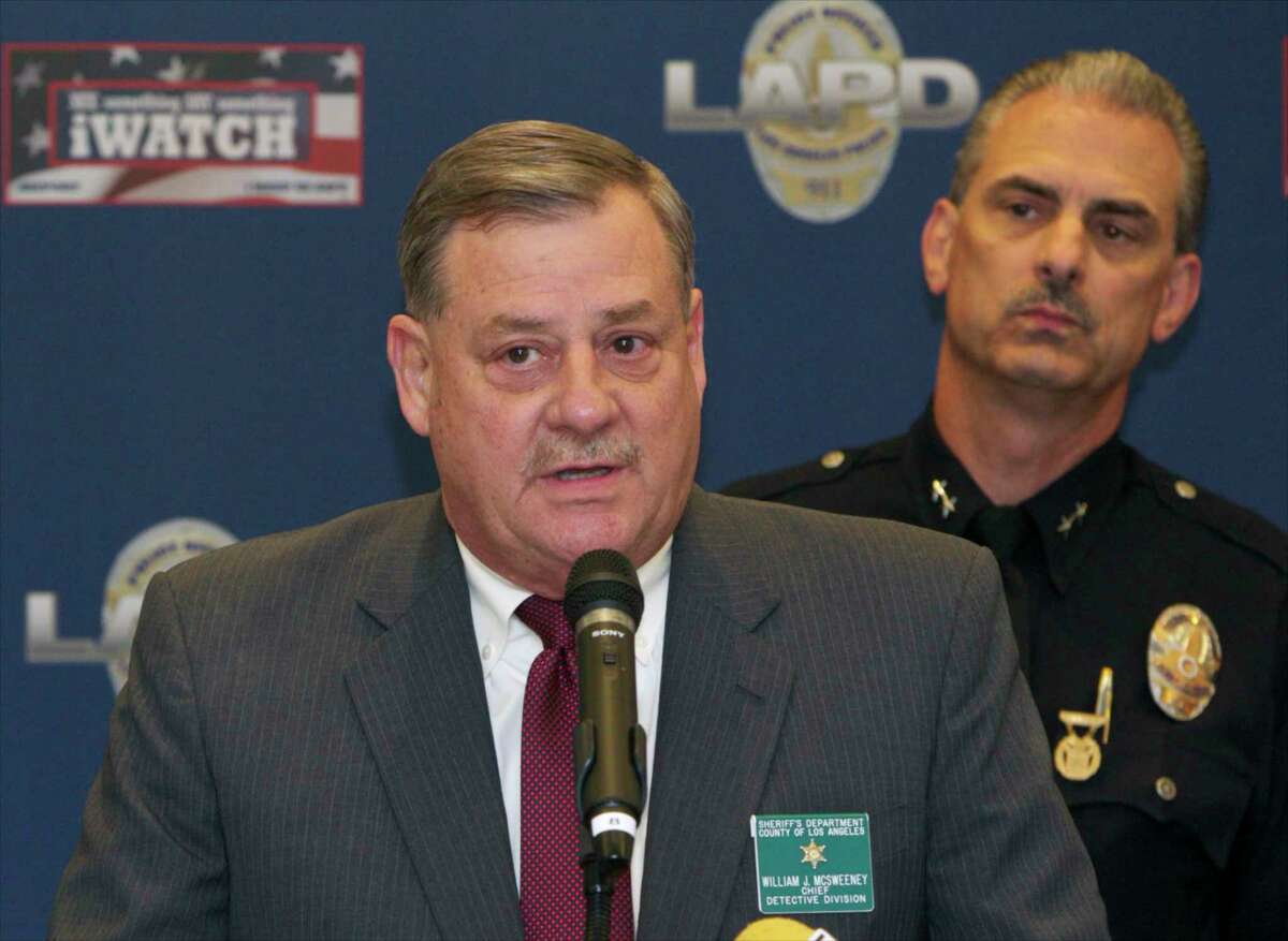 Bill McSweeney, Los Angeles County Sheriff's Department Chief Detective Division, left, with Los Angeles Police Department Deputy Chief Kirk Albanese take questions from the media during a news conference in Los Angeles, Tuesday, Aug. 26, 2014. Police say a man in custody is a serial killer who shot seven people, leaving four dead over five days. Deputy Chief Albanese said that the three other victims were critically injured and two dogs were also shot and killed before the arrest of 34-year-old Alexander Hernandez of Sylmar. Hernandez has only been charged in one of the killings but Los Angeles County sheriff's Chief of Detectives Bill McSweeney says he is a serial killer. (AP Photo/Damian Dovarganes)