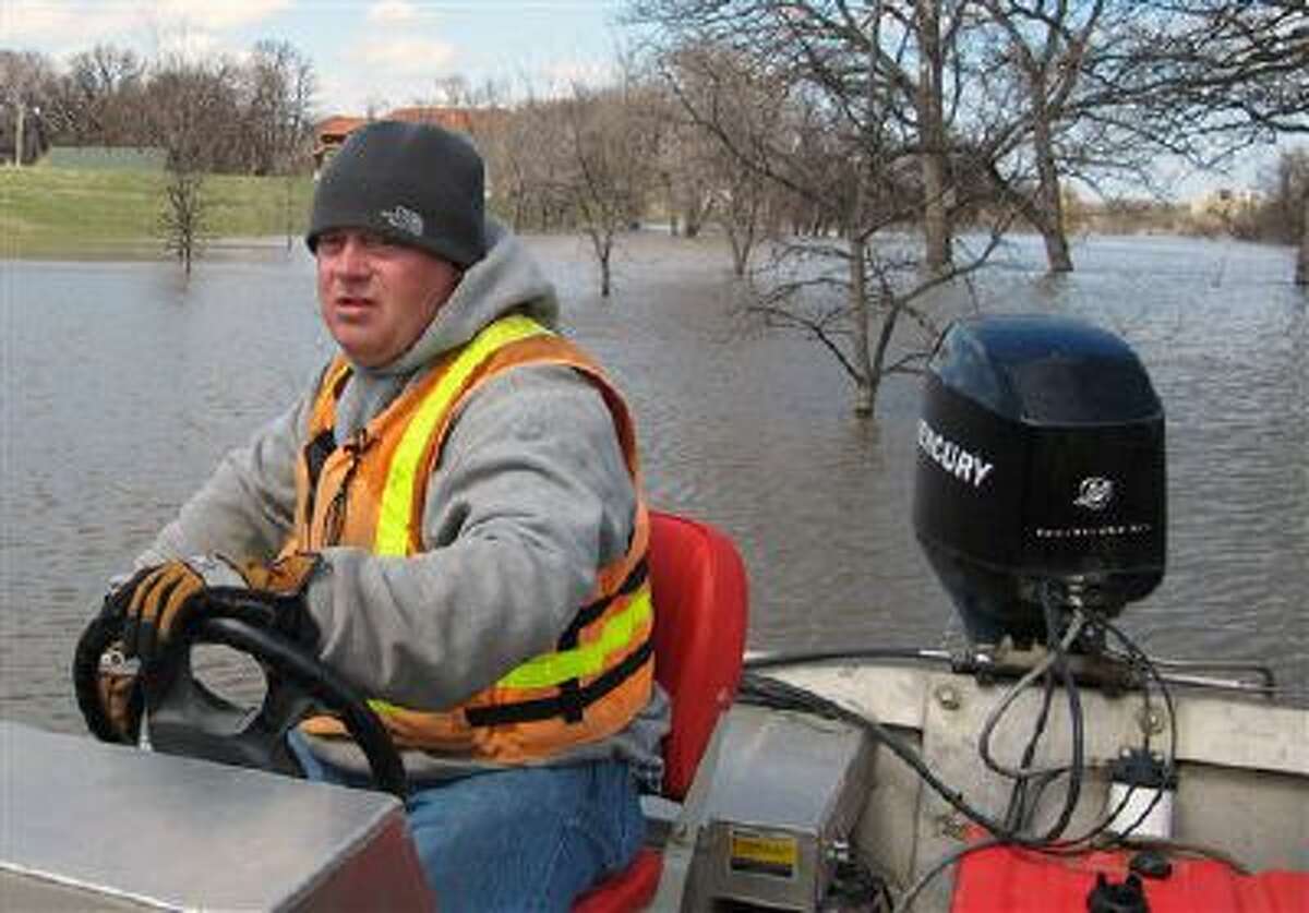 An official from the US Geological Survey works on the Red River on Fargo, N.D., in April. Water projects could be back on the table for Congress.