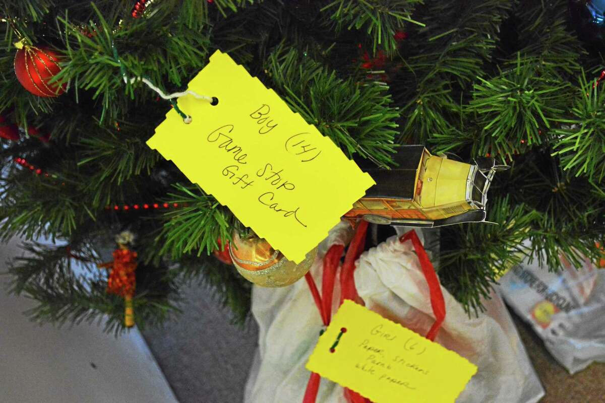 The trees are covered in tags with the name of a child, his or her age, sex and what they’d like for Christmas.