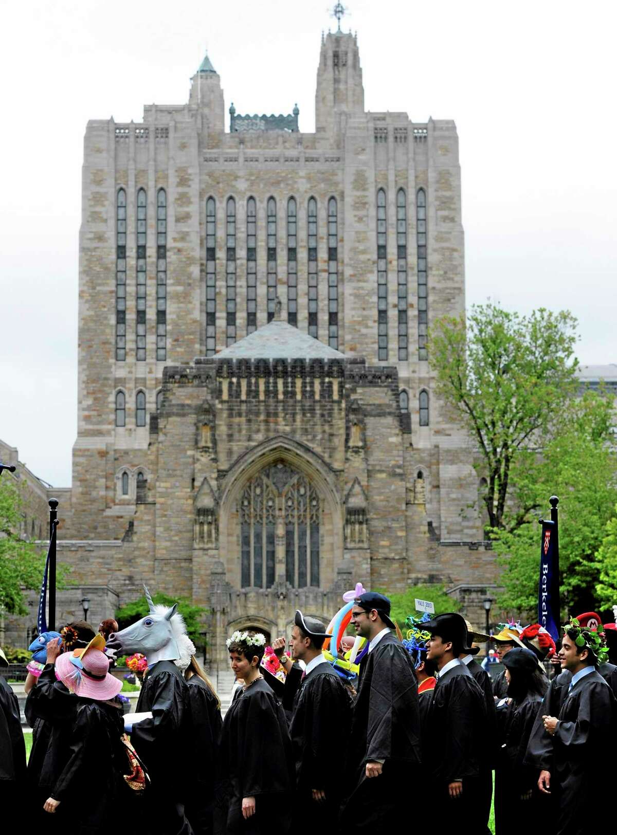 Students wearing decorative hats line up for the procession during Class Day for Yale seniors at Yale University in New Haven, Conn., Sunday, May 19, 2013. (AP Photo/Jessica Hill)