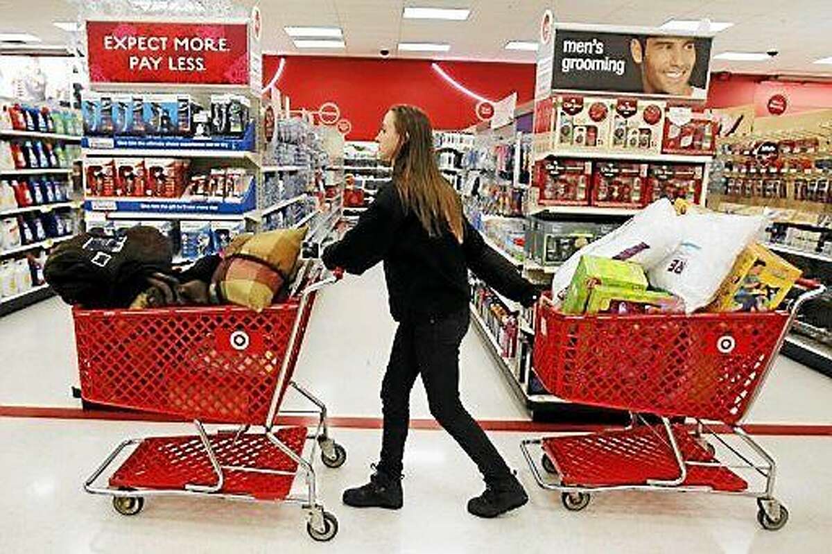 A woman pulls two shopping carts through the Torrington Target store. Police are investigating the theft of iPads from the East Main Street store during a burglary Wednesday afternoon.
