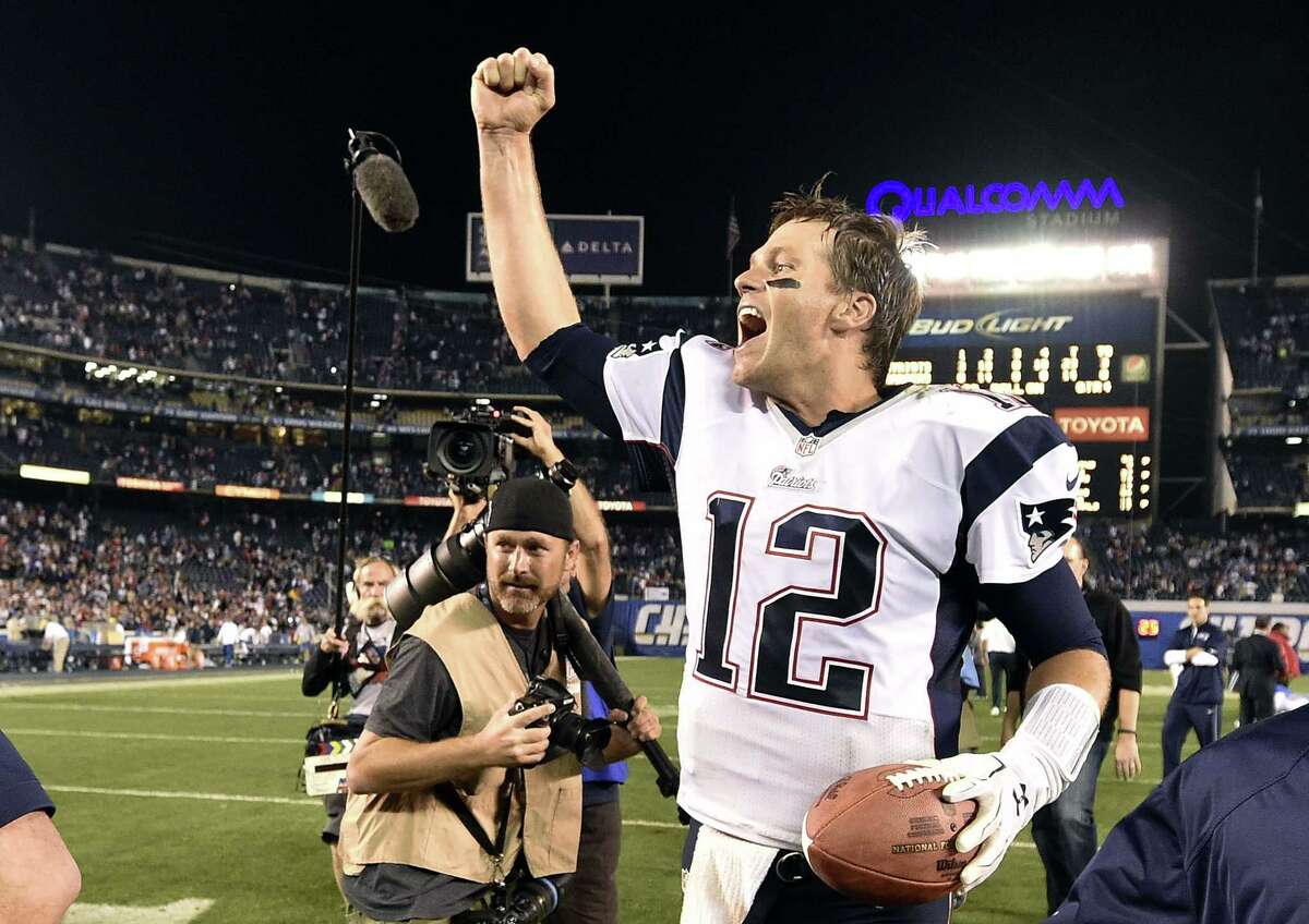 New England quarterback Tom Brady celebrates after the Patriots defeated the Chargers 23-14 on Sunday in San Diego.