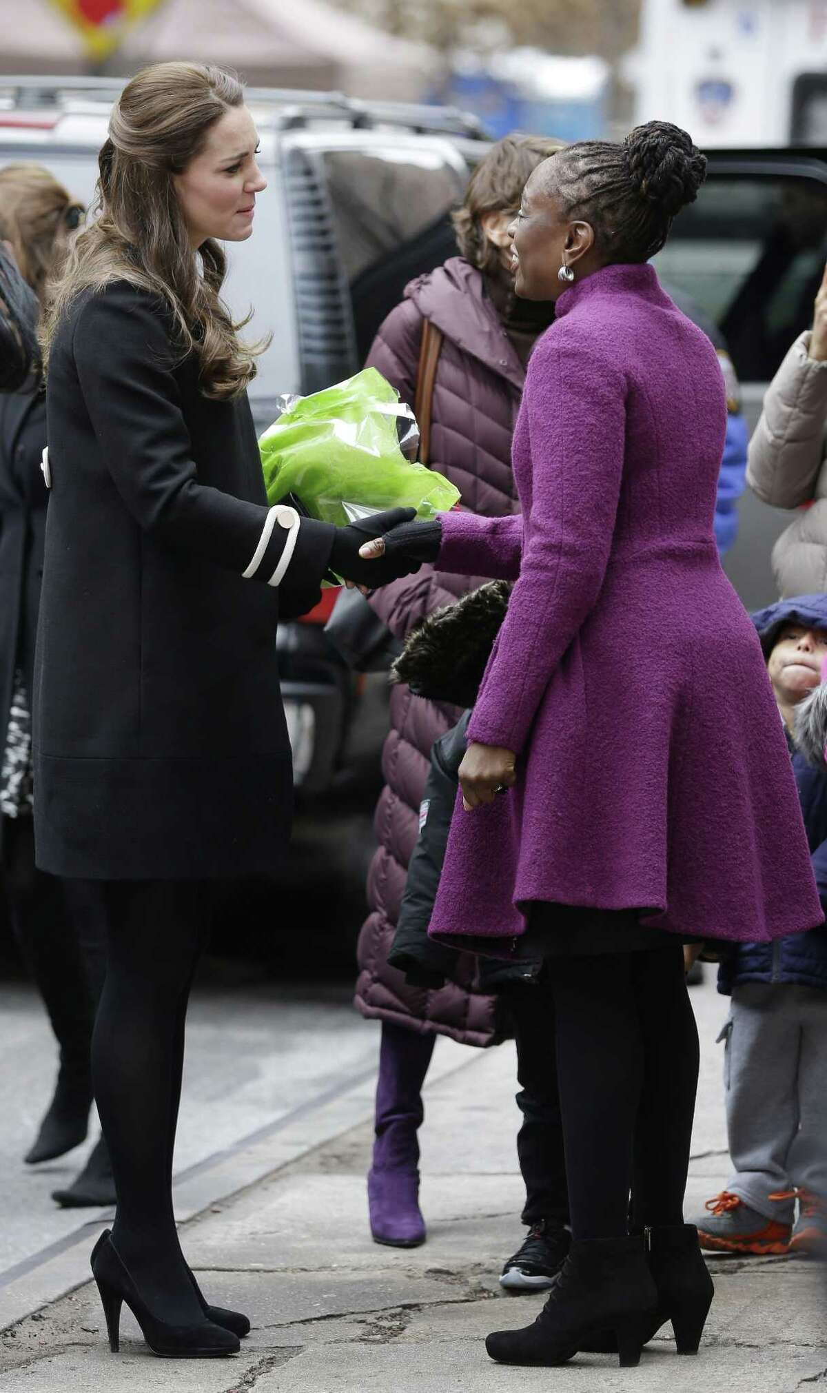 Kate Middleton, the Duchess of Cambridge, left, shakes hands with Chirlane McCray, wife of New York City Mayor Bill de Blasio, after leaving the Northside Center for Childhood Development in New York, Monday, Dec. 8, 2014. (AP Photo/Seth Wenig, Pool)