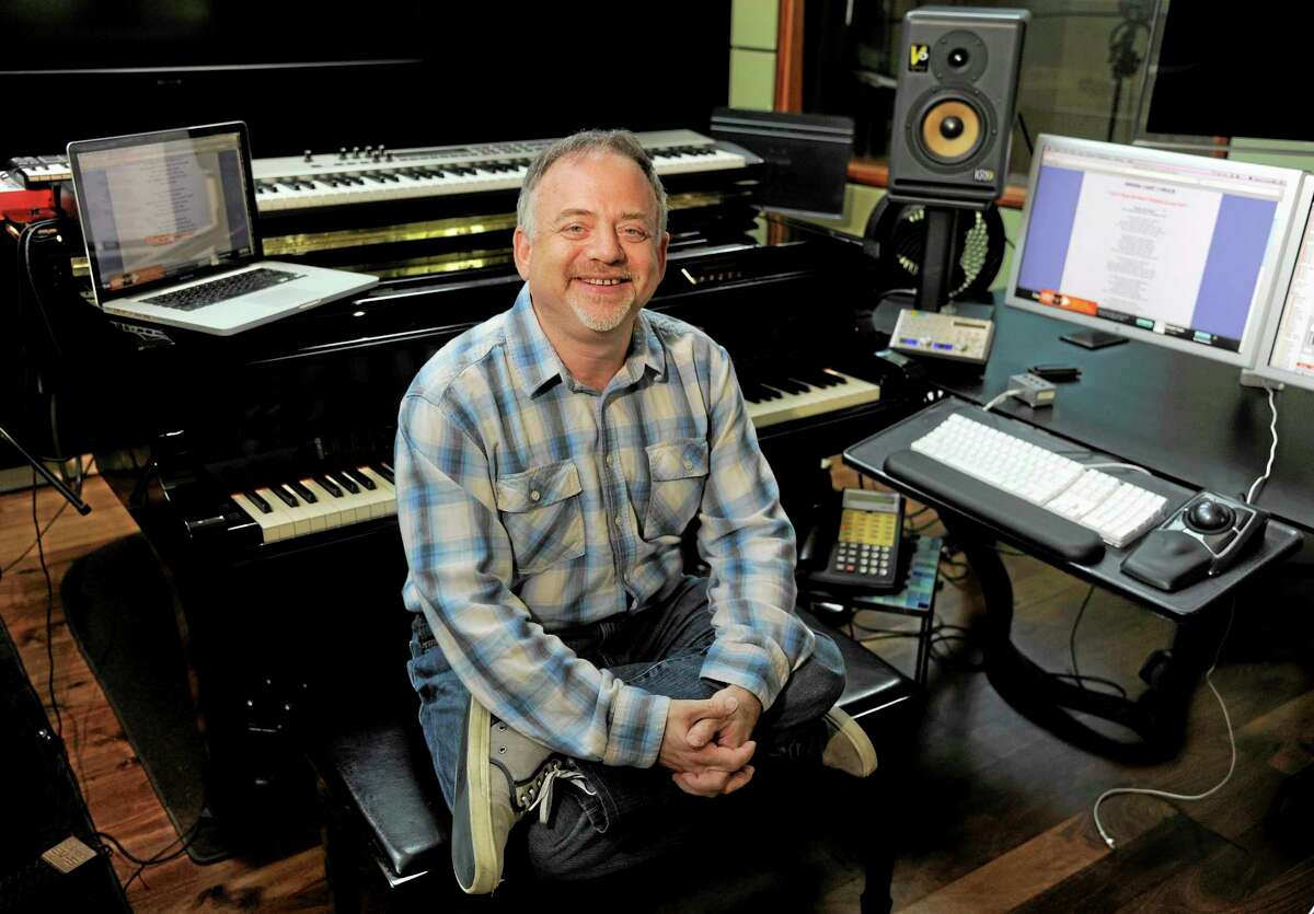 In thsi Wednesday, Aug. 14, 2013 photo, composer Marc Shaiman poses at his home recording studio in Los Angeles. Shaiman and partner Scott Wittman are nominated for an Emmy for their song, "Hang the Moon," from TV's "Smash." Their latest stage musical, "Charlie and the Chocolate Factory," is a hit on London's West End. (Photo by Chris Pizzello/Invision/AP)