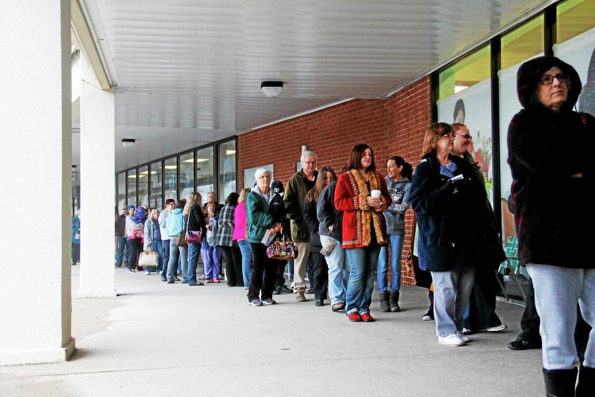More than 200 people wait in line during the grand opening of JoAnn Fabrics on Thursday, March 20, 2014, in Torrington.