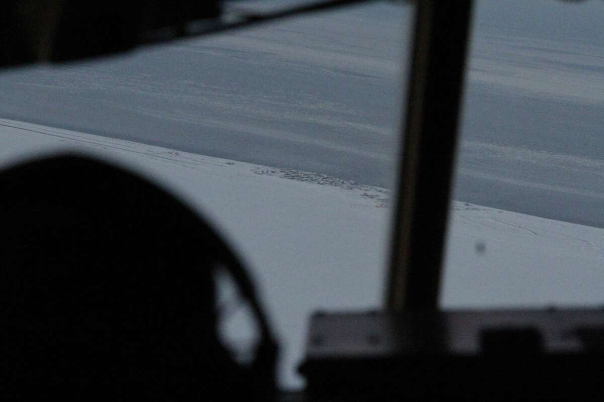 This photo taken Dec. 6, 2014, shows the community of Shishmaref, Alaska, as seen from the cockpit of an approaching C130 military transport plane. The Alaska National Guard provided transport for the good Samaritan program Operation Santa, which took gifts and schools supplies to about 300 children in the Inupiat Eskimo community. (AP Photo/Mark Thiessen)