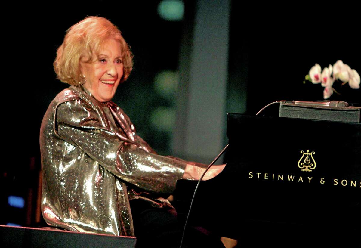 FILE - In this March 19, 2008 file photo, Marian McPartland smiles while playing the piano during a celebration of her 90th birthday in New York. McPartland, 95, the legendary jazz pianist and host of the National Public Radio show "Piano Jazz," died of natural causes Tuesday, Aug. 20, 2013 at her Port Washington home on Long Island. (AP Photo/Seth Wenig, File)