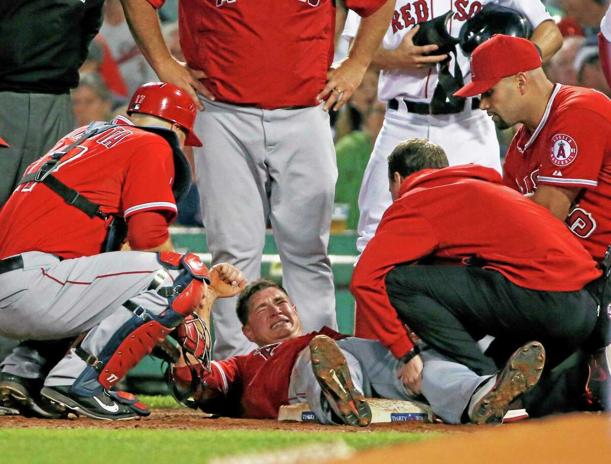 Los Angeles Angels starter Garrett Richards is attended to on the field after injuring his knee during the second inning of Wednesday’s game against the Red Sox at Fenway Park in Boston.