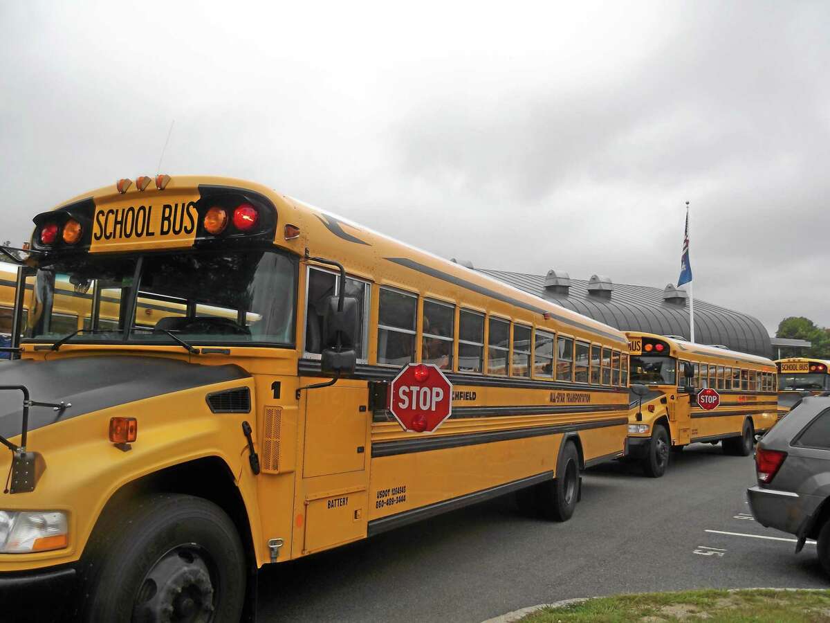 Buses line up outside Litchfield High School to bring students home from their first day of school in September 2012.
