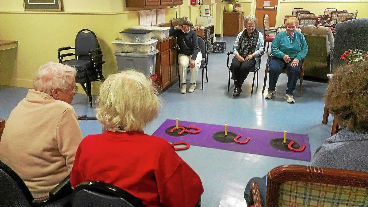 Seniors picture playing horse shoe at Winsted’s YMCA adult day care center.
