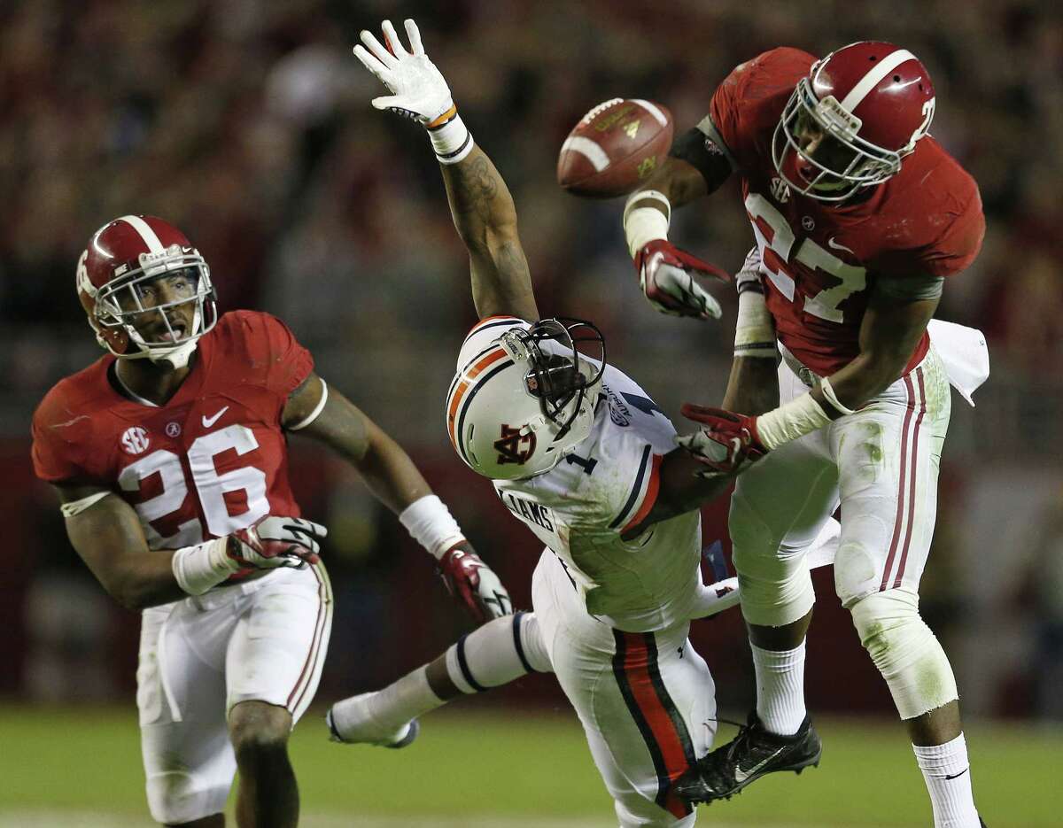 Alabama defensive back Nick Perry (27) breaks up a pass on Auburn wide receiver D’haquille Williams (1) as Alabama defensive back Landon Collins (26) looks on during the second half of the Iron Bowl NCAA college football game, Saturday, Nov. 29, 2014, in Tuscaloosa, Ala. Alabama won 55-44.