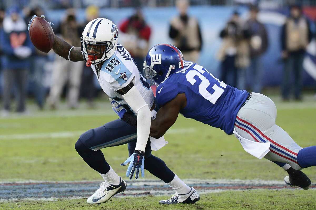 Tennessee Titans wide receiver Nate Washington (85) is defended by New York Giants free safety Stevie Brown (27) in the second half of an NFL football game Sunday, Dec. 7, 2014, in Nashville, Tenn. (AP Photo/Mark Zaleski)