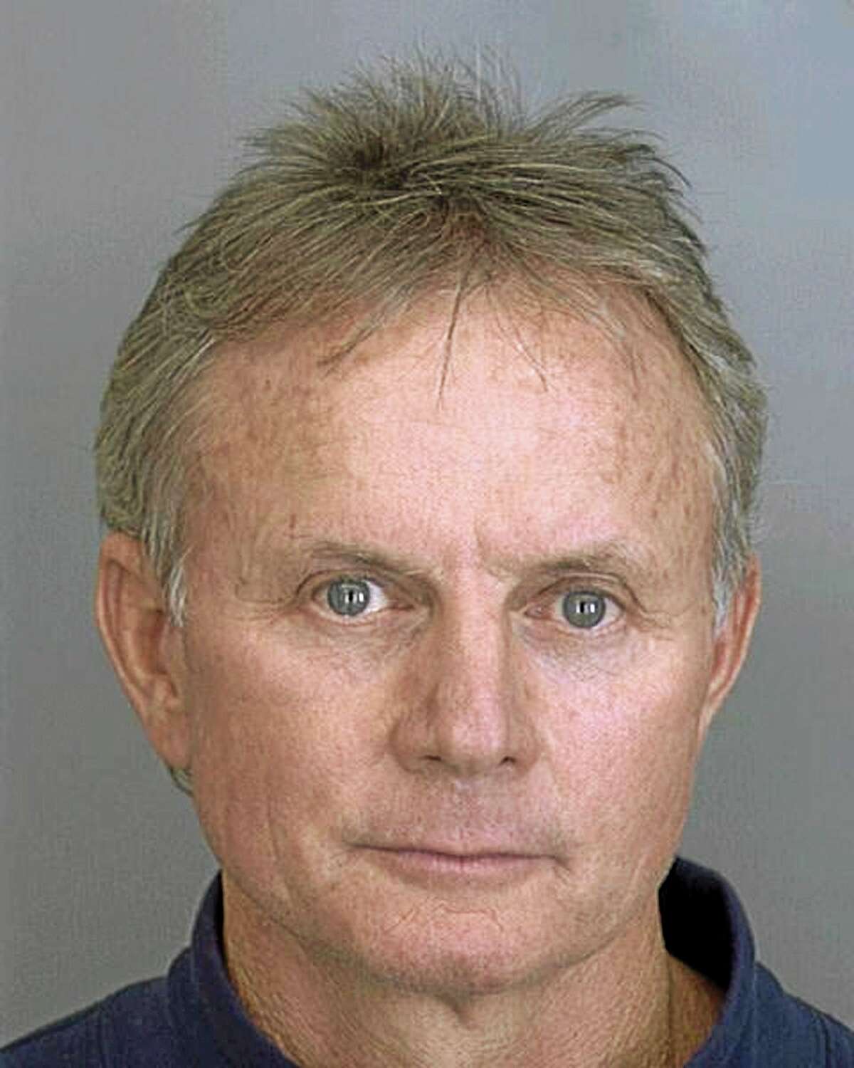 FILE - This Nov. 2, 2001 booking file photo, provided by the Dallas County Sheriff's Department show Dr. Wayne Scott Harrington, a Tulsa, Okla., dentist. The oral surgeon whose filthy clinics led to the testing of thousands of patients for HIV and hepatitis permanently surrendered his professional license on Friday, Aug. 22, 2014. (AP Photo/Dallas County Sheriff Department, File)