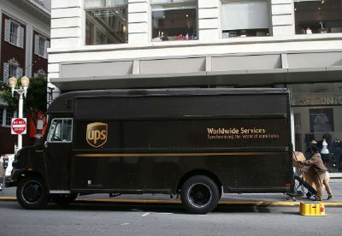 A UPS worker unloads packages from his truck on Dec. 20, 2012 in San Francisco.