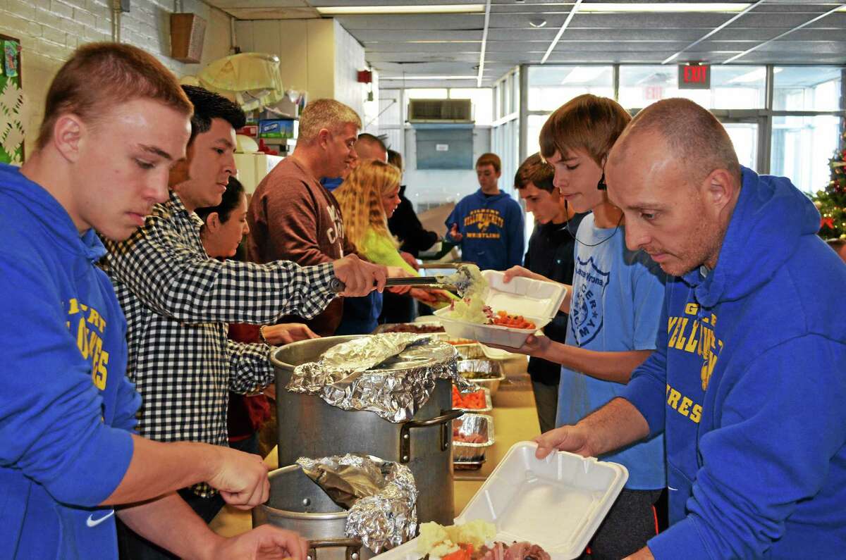 Members of the Gilbert School wrestling team served meals to the homeless at the Winsted YMCA on Christmas.