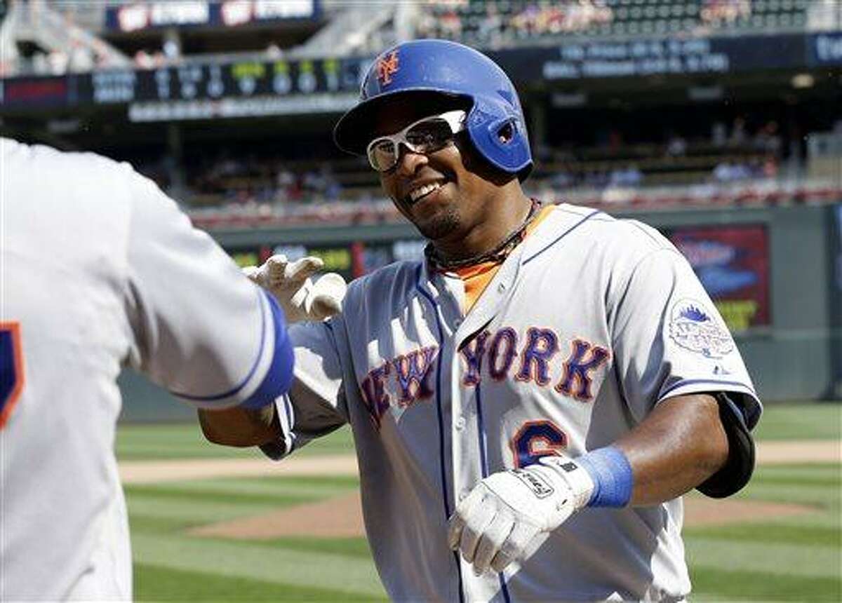New York Mets' Marlon Byrd is all smiles after his solo home run off Minnesota Twins pitcher Jared Burton in the ninth inning of a baseball game, Monday, Aug. 19, 2013 in Minneapolis. The Mets won 6-1. (AP Photo/Jim Mone)