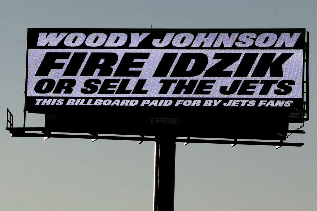 A sign directed at New York Jets owner Woody Johnson is seen on the side of Route 3 near MetLife Stadium on Nov. 28 in East Rutherford, N.J.