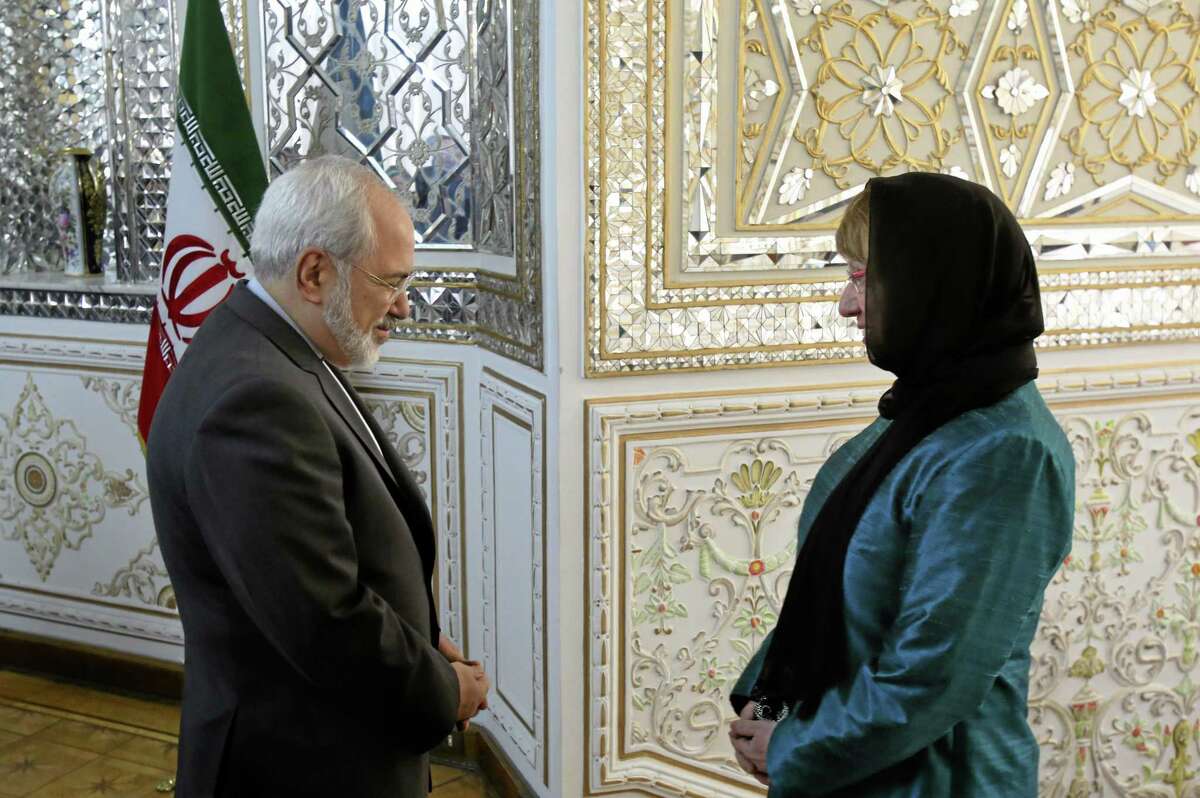 Iranian Foreign Minister Mohammad Javad Zarif, left, welcomes European Union’s foreign policy chief Catherine Ashton for their meeting, in Tehran, Iran, Sunday, March 9, 2014. Ashton is saying there is no guarantee for a successful final nuclear deal with Iran.