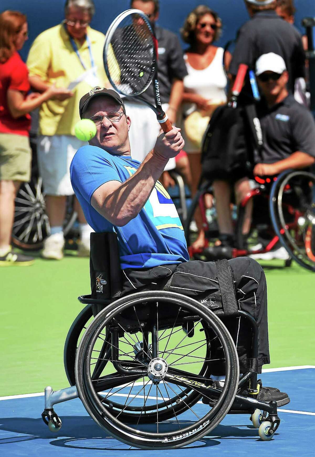(Mara Lavitt ó New Haven Register) August 20, 2014 New Haven Gaylord Sports Assoc. brought wheelchair tennis team members, as well as athletes from the Magic Lincer Tennis Academy in Windsor to conduct an adaptive tennis demonstration at the Connecticut Open. Ryan Martin of Monroe returns. mlavitt@newhavenregister.com