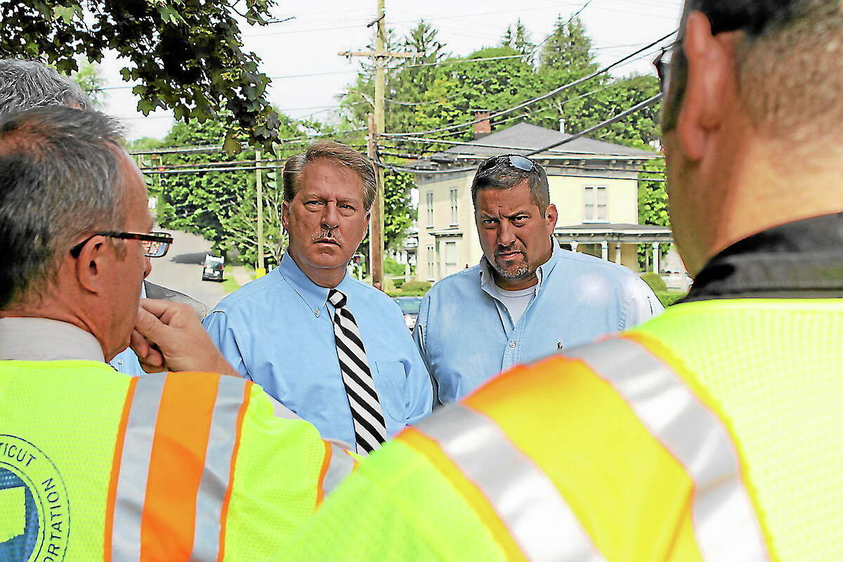 State Reps. David A. Scribner and Jay Case talk with state Department of Transportation officials about infrastructure improvements needed to Winsted’s Holabird Avenue Bridge on Monday, Aug. 19.