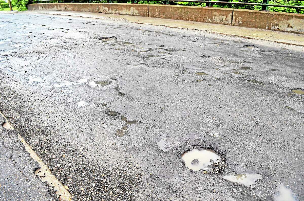 Potholes line Winsted’s, Holabird Avenue bridge as seen on Thursday, June 13.