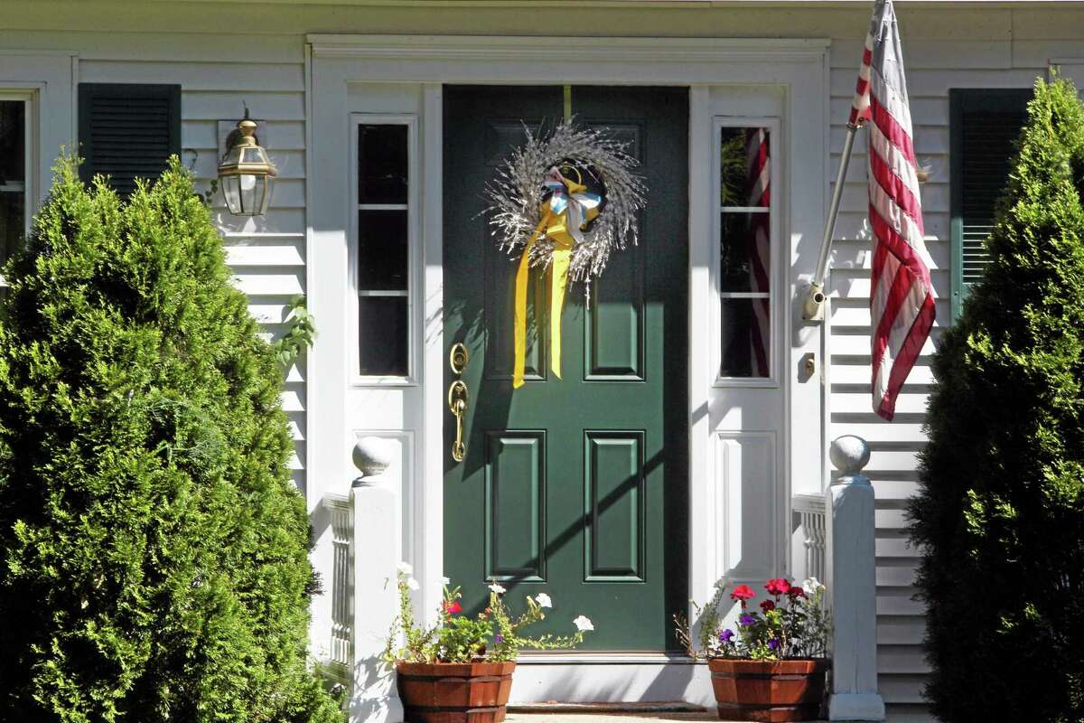 A ribbon is seen on the front door of the family home of freelance journalist James Foley, Wednesday, Aug. 20, 2014 in Rochester, N.H. Foley was abducted in November 2012 while covering the Syrian conflict. On Tuesday, Aug. 19, militants with the Islamic State extremist group released a video showing Islamic State militants beheading Foley in an act of revenge for U.S. airstrikes in northern Iraq . (AP Photo/Jim Cole)